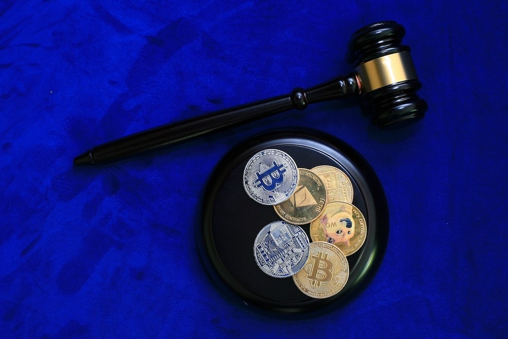 Crypto coins and gavel with blue background